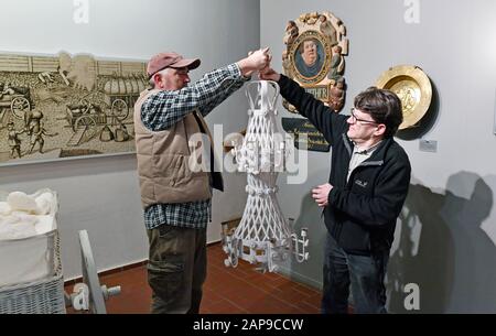 14 January 2020, Saxony-Anhalt, Halle (Saale): Sebastian Schwarzbach (l) and Christian Schwela from the Technical Halloren and Salt Museum in Halle take a typical salt chandelier from the ceiling. The museum will be completely renovated and converted by 2022. After the refurbishment, around 60,000 visitors per year are expected. Until then, selected museum objects will be on display at the Stadtmuseum Halle from April 2020. Photo: Hendrik Schmidt/dpa-Zentralbild/ZB Stock Photo