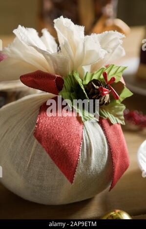 A Christmas pudding wrapped in a muslin cloth. Stock Photo