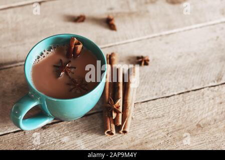 masala chai with spices. Cinnamon Stick, Thai Cardamom, Star Anise, Black Peppercorns, Fennel Seeds Black Tea Stock Photo