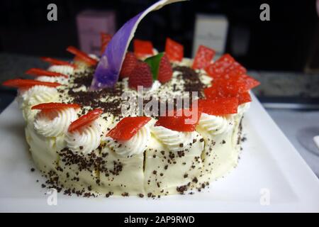 Iced Lemon Sponge Cake Decorated with Raspberry's, Cream & Chocolate, Azul Beach Resort Hotel, Puerto Morelos, Riviera Maya, Cancun. Mexico. Stock Photo