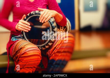 Young lady drummer with her djembe drum. Stock Photo