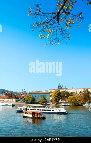 PRAGUE, CZECH REPUBLIC - OCTOBER 14, 2018: A view of the Vltava River, with some tourist boats in the foreground and the Prague Castle in the backgrou Stock Photo