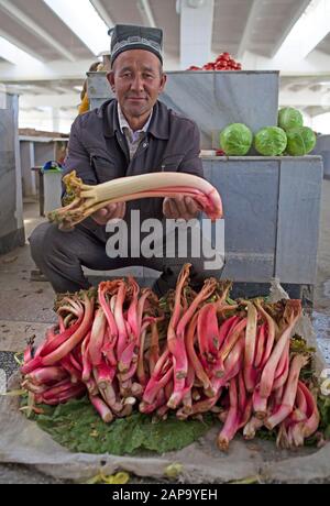 Native man sells rhubarb, Siyob bazaar Samarkand, Samarqand Province, Uzbekistan Stock Photo