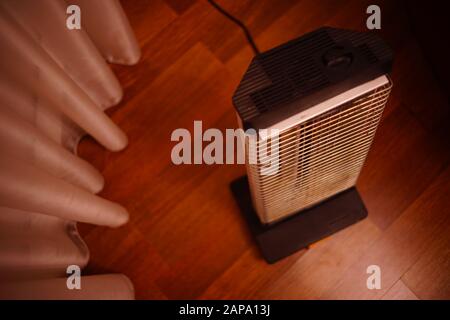 Retro electric heater Ugolek in the room on parquet floor Stock Photo