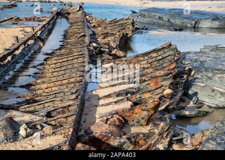 ribs of a ship wreck exposed on the beach after a high tide Constantine Bay beach North Cornwall, UK Stock Photo