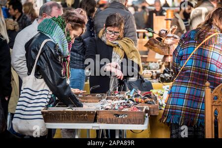 Spitalfield's antique market. Shoppers looking through items for sale at London's popular Spitalfields market. Stock Photo