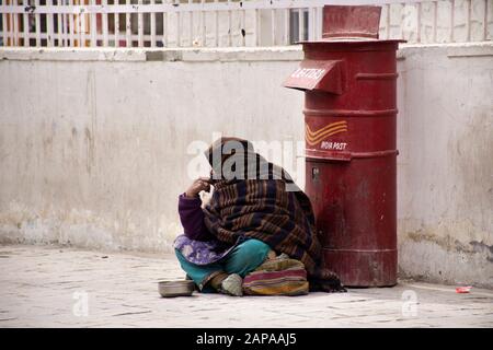 JAMMU KASHMIR, INDIA - MARCH 19 : Old indian women beggar or untouchables caste sitting and begging money from travelers people in market at Leh Ladak Stock Photo