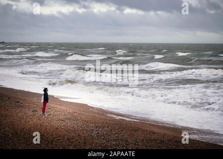 woman standing on  Brighton beach Stock Photo