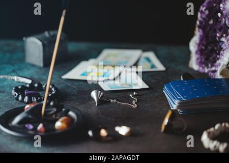 Tarot cards are surrounded magic things on a table.Mystical and occult concept. Stock Photo