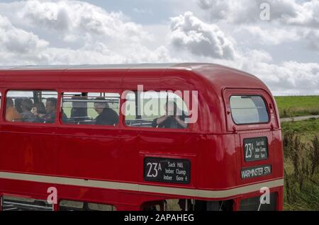 Wiltshire, UK - August 17, 2019: Sightseers on the top deck of a London bus in the military controlled Salisbury Plain. The bus route runs on only one Stock Photo