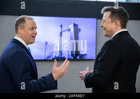 Kennedy Space Center, United States. 22nd Jan, 2020. NASA Administrator Jim Bridenstine, left, and SpaceX Chief Engineer Elon Musk converse inside Firing Room 4 in Kennedy Space Center's Launch Control Center while awaiting the liftoff of a SpaceX Falcon 9 rocket and Crew Dragon spacecraft on the uncrewed In-Flight Abort Test, January 19, 2020. The test demonstrated the spacecraft's escape capabilities in preparation for crewed flights to the International Space Station as part of the agency's Commercial Crew Program. NASA Photo by Kim Shiflett/UPI Credit: UPI/Alamy Live News Stock Photo