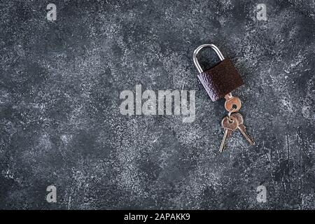 Iron lock with keys on grey background. Top view. Stock Photo