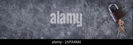 Iron lock with keys on grey background. Top view. Banner Stock Photo