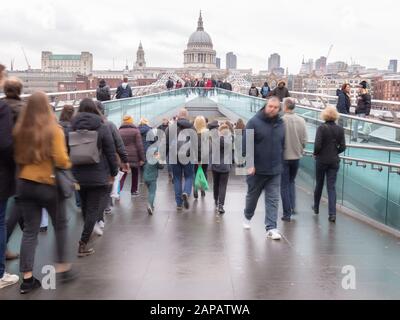 London, England - november of 2019.  Crowdy Millennium Bridge in autumn day. Breidge over Thames river connecting St. Paul's Cathedral and Tate Modern Stock Photo