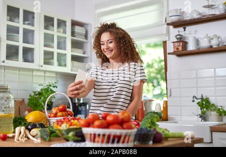 Young woman taking picture of herself Stock Photo