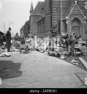 Recovery: Amsterdam Description: Amsterdam. Zaanstraat near Saint Mary Magdalene Church. Under the leadership of the captain J. Breman, the 2nd Genie Company in Amsterdam started to repair work of very far-reaching scope. Its task is to remove all traffic barriers in the city of Amsterdam as soon as possible, including clearing works in the port. The work also consists of cleaning up barriers made by the Germans in the streets, sealing the gapings caused by wooden blocks: pumping out flooded cellars, etc. Amsterdam had been installed and which, especially in the evening, pose a serious danger, Stock Photo
