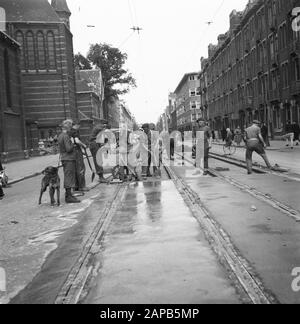 Recovery: Amsterdam Description: Amsterdam. Spaarndammerstraat near Saint Mary Magdalene Church. Under the leadership of the captain J. Breman, the 2nd Genie Company in Amsterdam started to repair work of very far-reaching scope. Its task is to remove all traffic barriers in the city of Amsterdam as soon as possible, including clearing works in the port. The work also consists of cleaning up barriers made by the Germans in the streets, closing the gapings caused by wooden blocks: pumping out flooded cellars, etc. Annotation: The church building of the architect P.J.H. Cuypers was demolished in Stock Photo