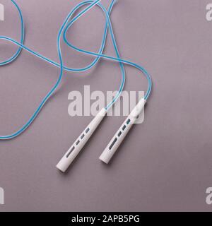 Jumping or skipping rope on gray background Stock Photo