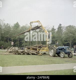 [Forestry demonstration gathering of logs] Date: undated Keywords: tree trunks, agricultural machinery, billboards, tow trucks, tools Personal name: knhm Stock Photo