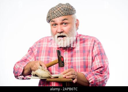 Shoe repair. mature shoemaker in workshop make shoes. shoemaker working with leather textile and hammer at workshop. retro man repair shoes with hammer. Cobbler workmanship. shoemaker at work. Stock Photo