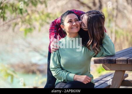 Mother and daughter enjoing their relationship in a park with a nice weather Stock Photo