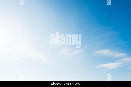 Bright and soft blue sky with small white clouds Stock Photo