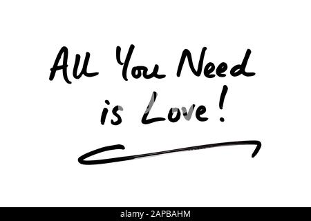 Close-up of the phrase All You Need Is Love! handwritten on a white background. Stock Photo