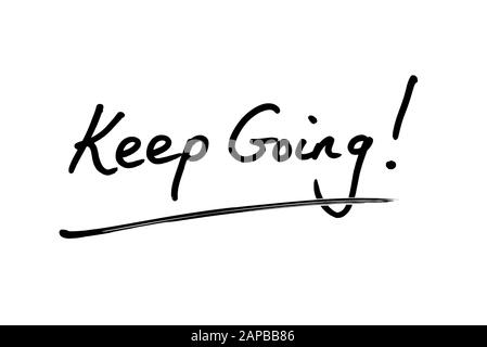 Close-up of a Keep Going! message handwritten on a white background. Stock Photo