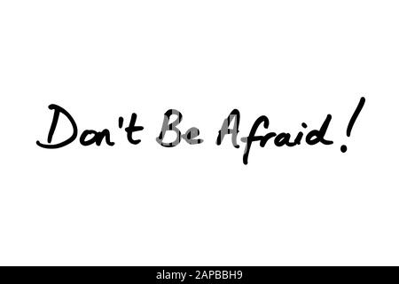Close-up of a Don’t Be Afraid! message handwritten on a white background. Stock Photo