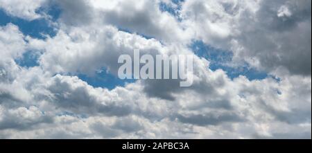 Fluffy clouds in the overcast sky view. Climate, environment and weather concept sky background. Stock Photo