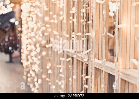 Yellow garland of lights on the window frames of a restaurant or cafe. Christmas or New Year decorations Stock Photo