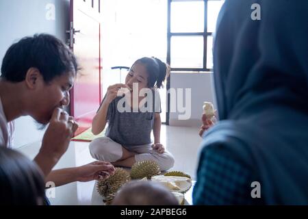 friend sharing and eat durian fruits Stock Photo