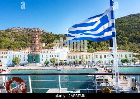 Tourists go to visit The Greek Orthodox Monastery of Taxiarchis Mihail Panormitis on Island of Symi  (Rhodes, Greece) Stock Photo