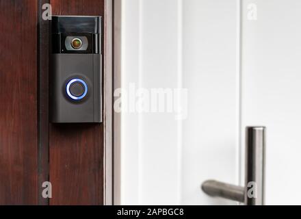 A modern surveillance camera is installed on a front door.A modern surveillance camera is installed on a front door. Stock Photo