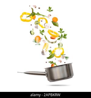 Healthy vegetarian eating and cooking with various flying chopped vegetables Stock Photo