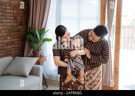 Portrait of a happy family wearing traditional Javanese clothes. concept of  family photo Javanese traditional clothes in the living room Stock Photo -  Alamy