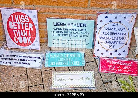 Funny sayings on plates on display; humorvolle Sprüche auf ausgestellten Metallplatten vor einem laden Stock Photo