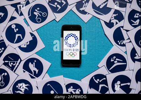 TOKYO, JAPAN, JANUARY. 20. 2020: Olympic Background, Mobile or Smartphone with logo of summer game in Tokyo 2020 and official pictogram of all sports Stock Photo