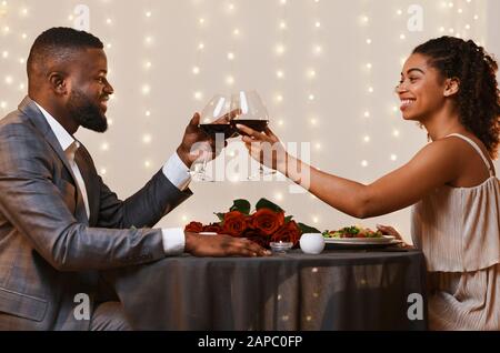 Handsome man and pretty woman drinking wine at restaurant Stock Photo
