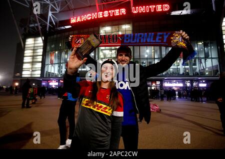 Fans pose for a photo outside the stadium ahead of the Premier League match at Old Trafford, Manchester. Stock Photo