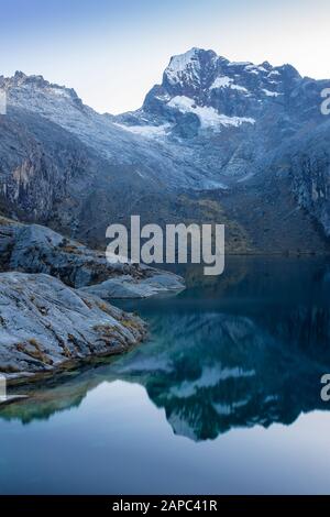Mountain in Peru reflecting in the lake in Huascarán National Park. Stock Photo