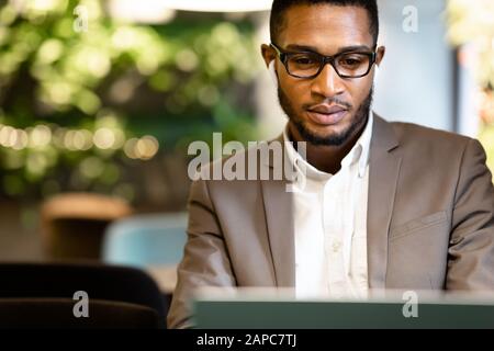 Portrait of black guy using pc listening to music Stock Photo