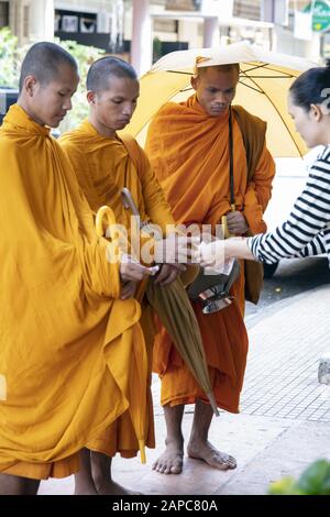 Novice monks or samaneras receiving alms in the morning Stock Photo