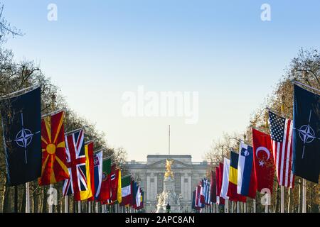 Buckingham Palace, official residence of the British monarch with the flags of the NATO nations lining the Mall, the street in front of the palace Stock Photo