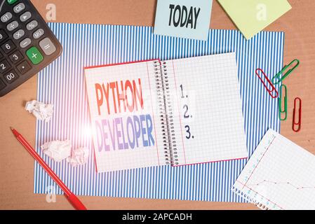 Writing note showing Python Developer. Business concept for responsible for writing serverside web application logic Striped paperboard notebook cardb Stock Photo