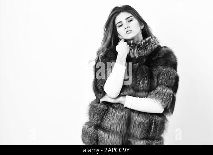 Fur store model enjoy warm in soft fluffy coat with collar. Woman makeup and hairstyle posing mink or sable fur coat. Fur fashion concept. Winter elite luxury clothes. Female brown fur coat. Stock Photo