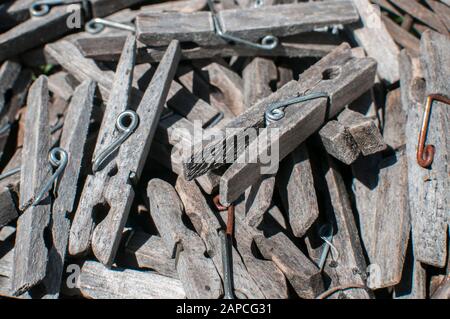Pile of weathered wooden laundry clamps closeup in reed basket Stock Photo