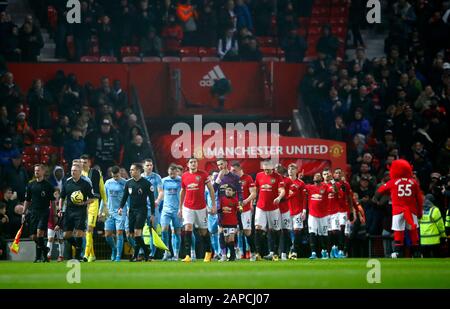 Manchester United and Burnley players walk out onto the pitch for the ...