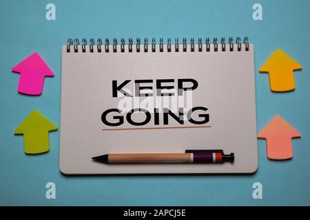Keep Going write on a book isolated on office desk. Christian faith concept Stock Photo