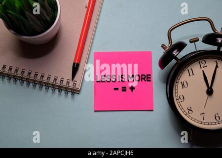 Less is More write on a sticky note isolated on office desk. Stock Photo